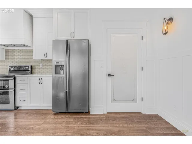 a view of a kitchen with wooden cabinet