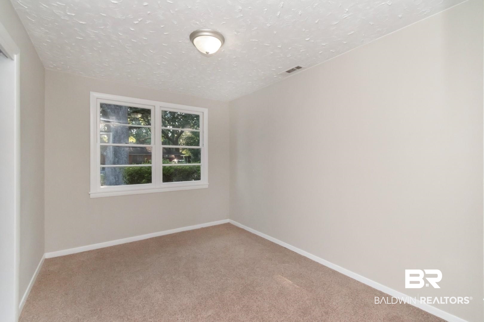 1220 Garland Drive Mobile, AL 36618 - Photo 15 of 25 Empty room with carpet and a textured ceiling