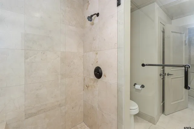 a bathroom with a toilet and shower