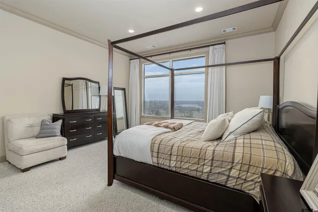 a bedroom with a bed couch and window