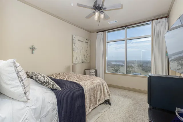 a bedroom with a large bed and a large window