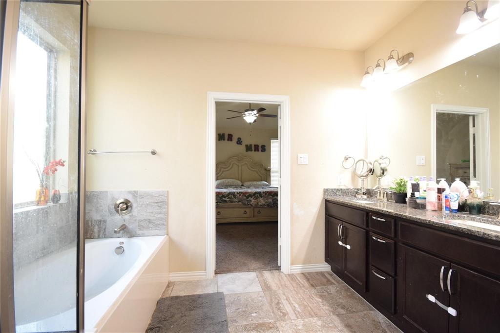 12421 Hitch Rack Way McKinney, TX 75071 - Photo 7 of 21 a en suite bathroom with a tub sink and mirror