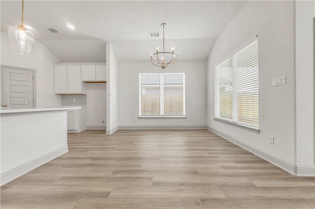 5955 Eldora Drive College Station, TX 77845 - Photo 14 of 36 a view of empty room with wooden floor and windows