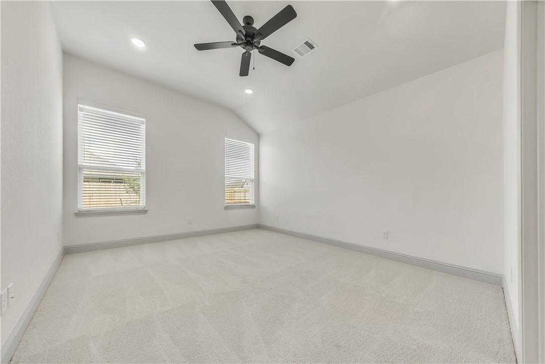5955 Eldora Drive College Station, TX 77845 - Photo 17 of 36 an empty room with windows and fan