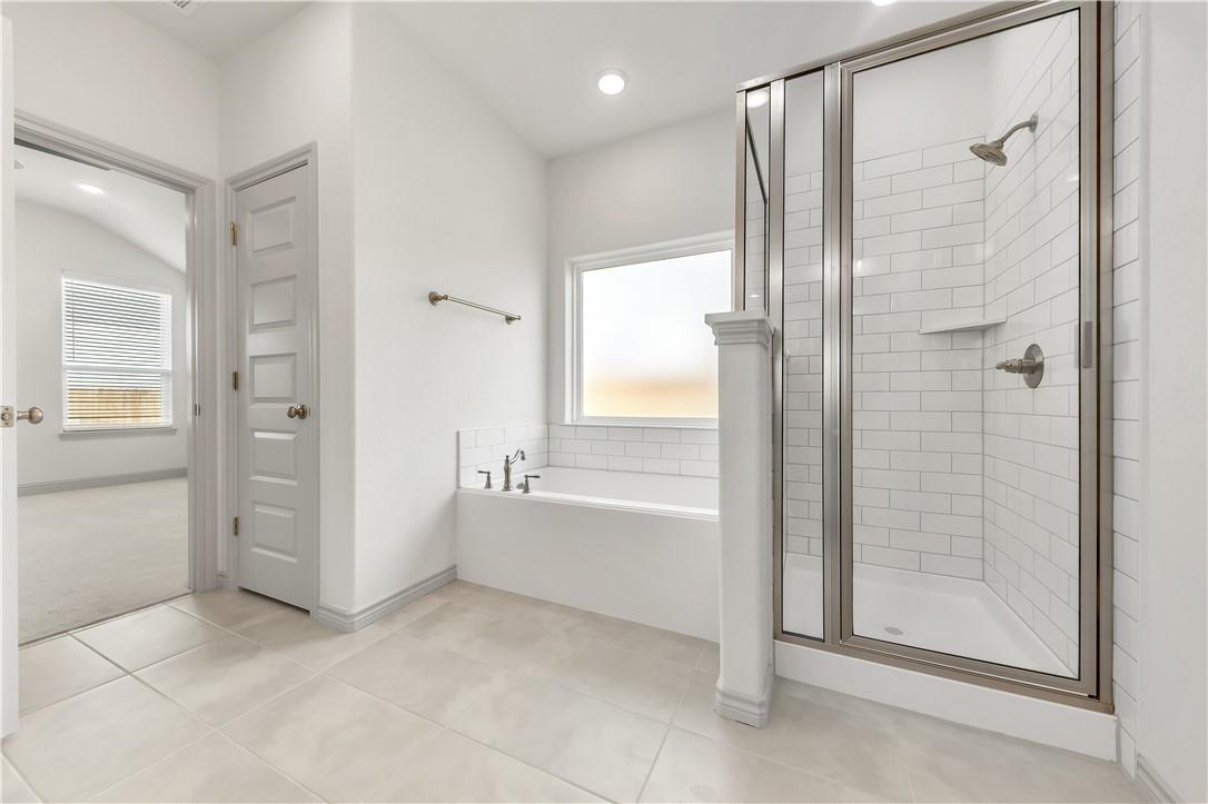 5955 Eldora Drive College Station, TX 77845 - Photo 21 of 36 a bathroom with a bathtub and a shower