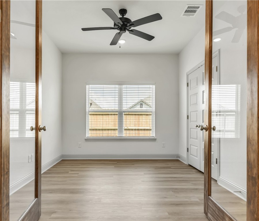 5955 Eldora Drive College Station, TX 77845 - Photo 22 of 36 a view of an empty room with wooden floor and a window