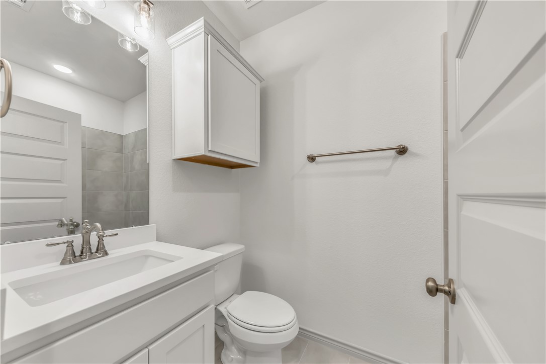 5955 Eldora Drive College Station, TX 77845 - Photo 26 of 36 a bathroom with a sink toilet and vanity