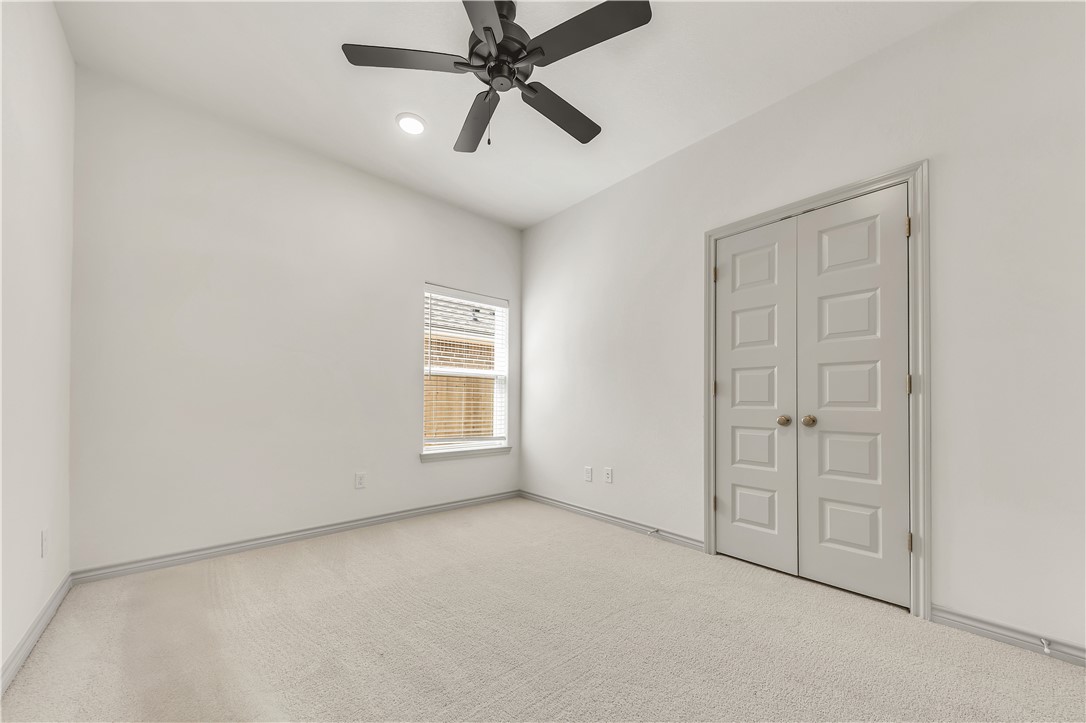 5955 Eldora Drive College Station, TX 77845 - Photo 27 of 36 an empty room with windows and fan