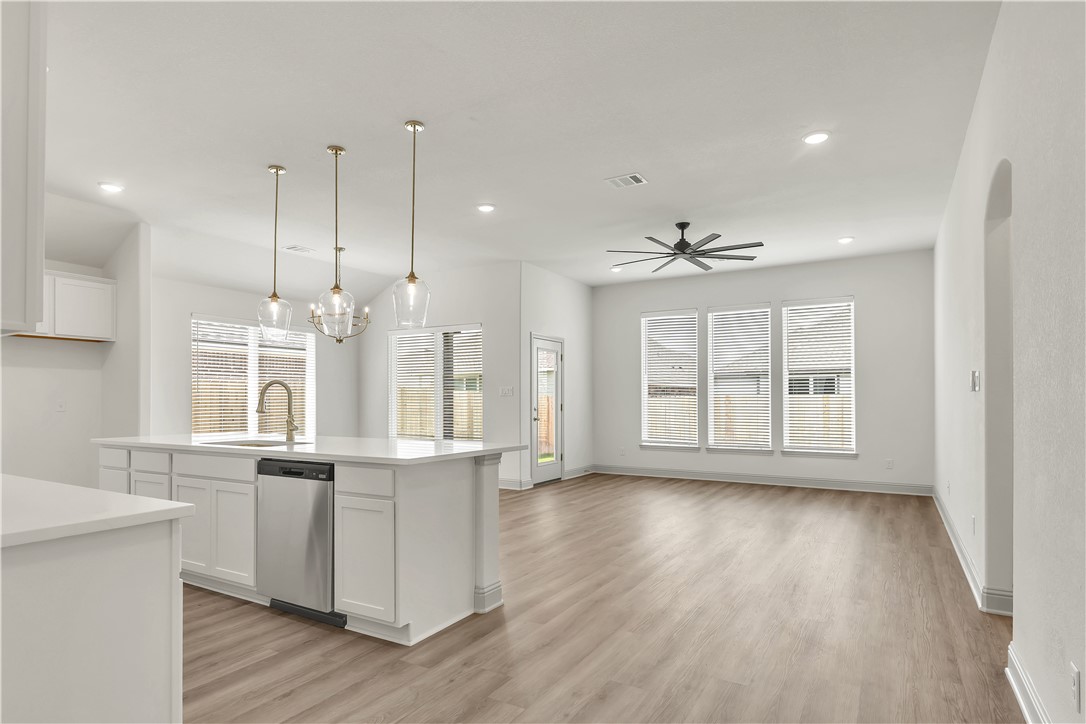 5955 Eldora Drive College Station, TX 77845 - Photo 3 of 36 a view of an empty room with wooden floor and a kitchen
