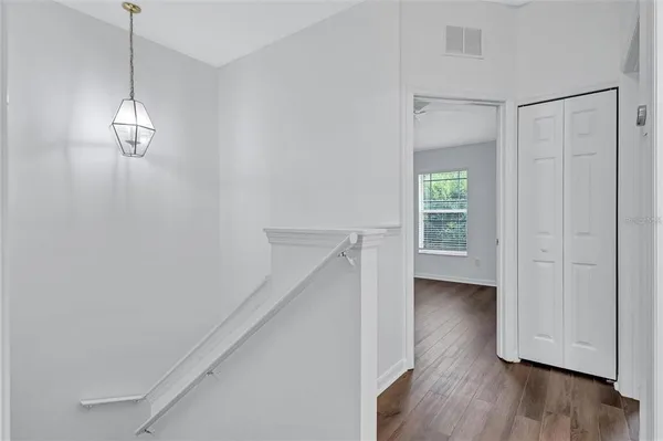 a view of a porch with a floor to ceiling window next to a yard