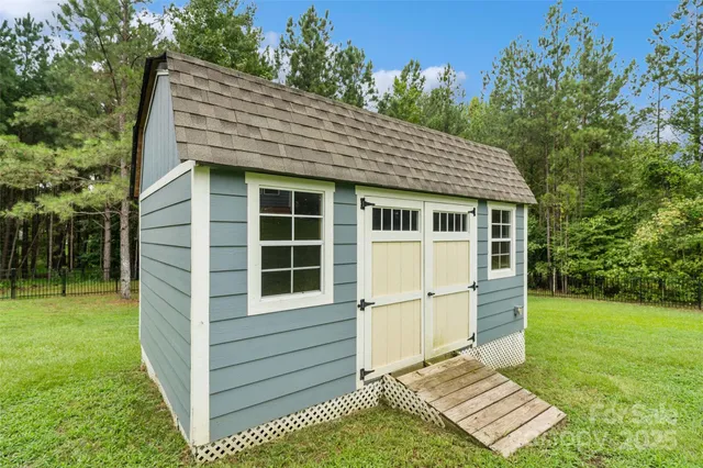 a front view of a house with a garden and yard