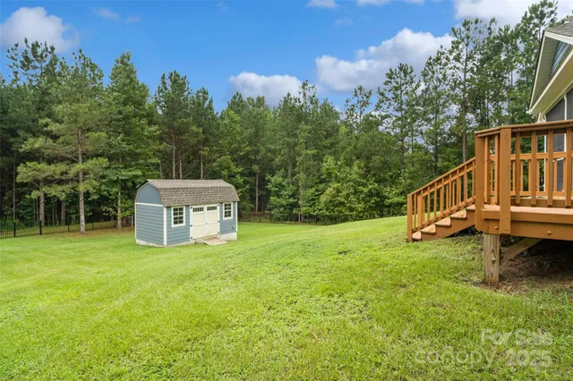 a aerial view of a house with a yard table and chairs