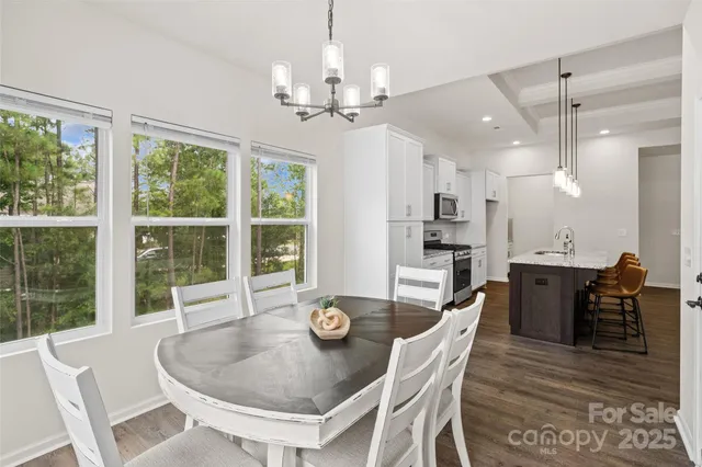a dining room with furniture a window and wooden floor