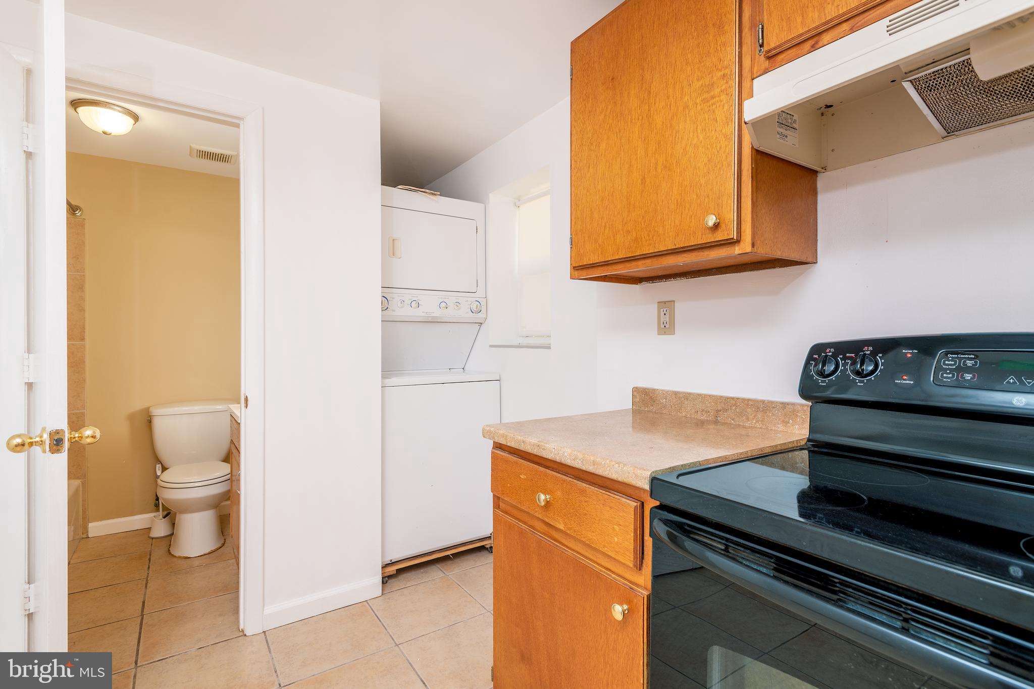 9103 Tower Road Randallstown, MD 21133 - Photo 6 of 28 Stack washer & dryer and full bath off kitchen
