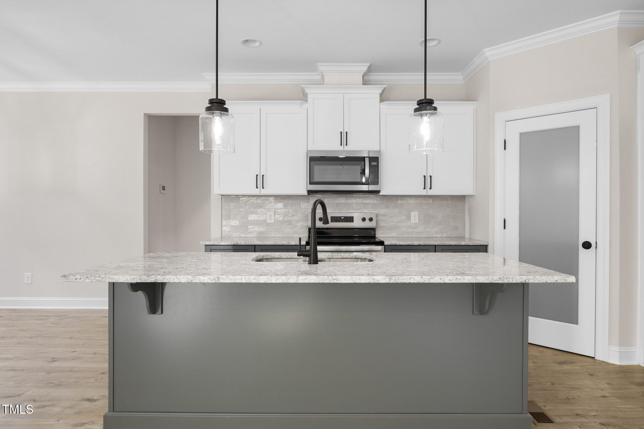 4948 Zebulon Road Zebulon, NC 27597 - Photo 11 of 35 a large kitchen with granite countertop a sink a counter top space appliances and cabinets