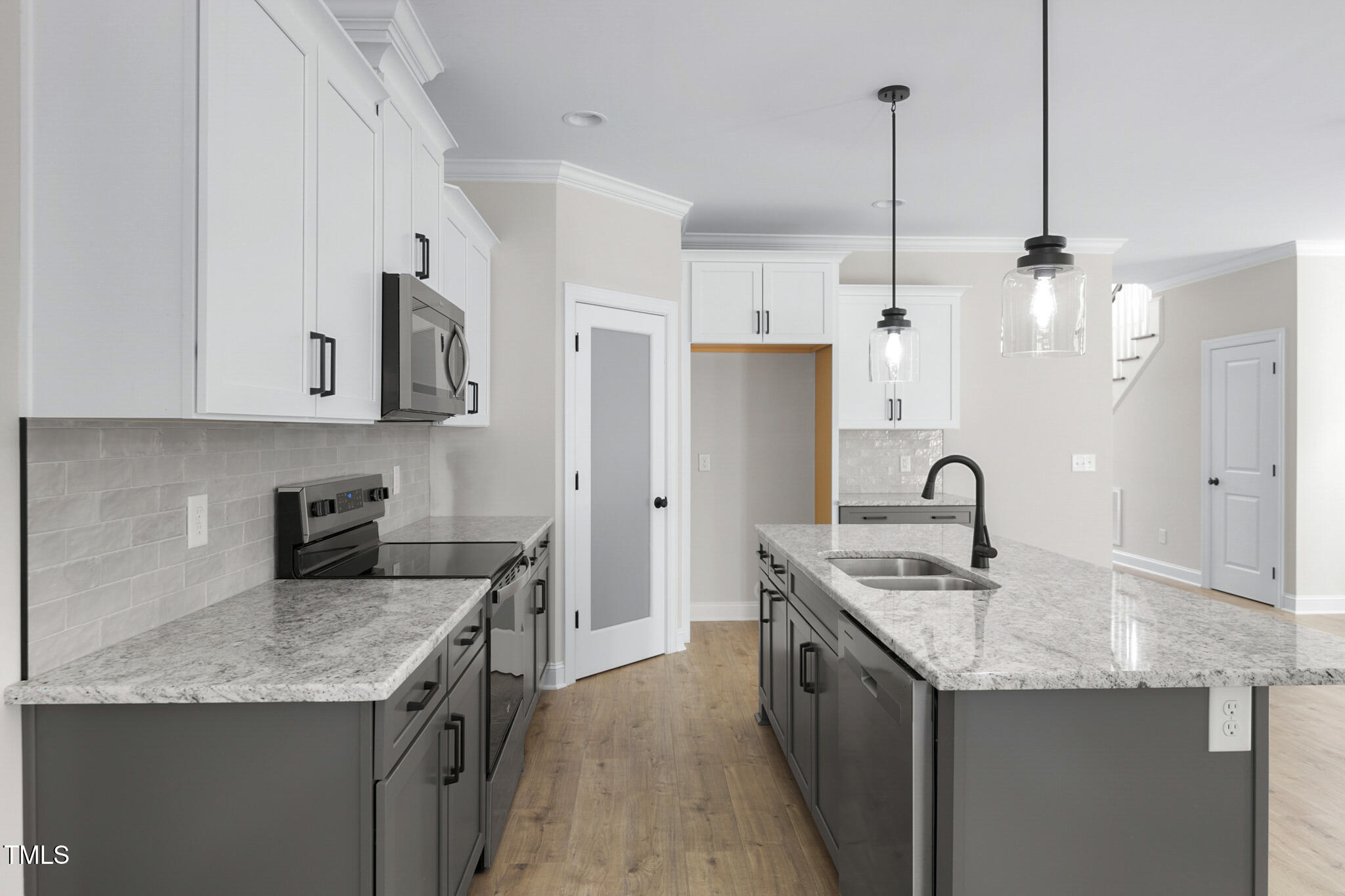 4948 Zebulon Road Zebulon, NC 27597 - Photo 12 of 35 a kitchen with stainless steel appliances granite countertop a sink a stove a refrigerator a center island and cabinets