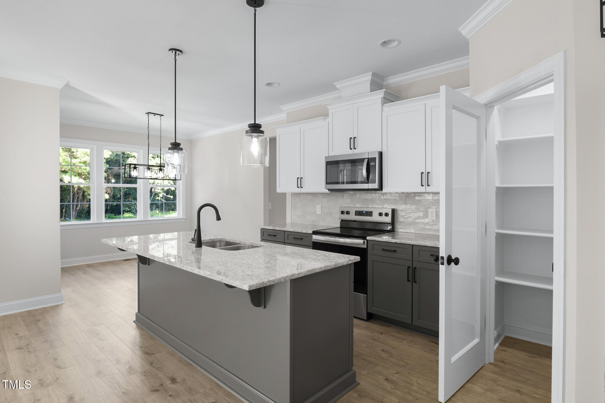 4948 Zebulon Road Zebulon, NC 27597 - Photo 13 of 35 a kitchen with stainless steel appliances granite countertop a sink a stove a refrigerator a center island with wooden floor and cabinets