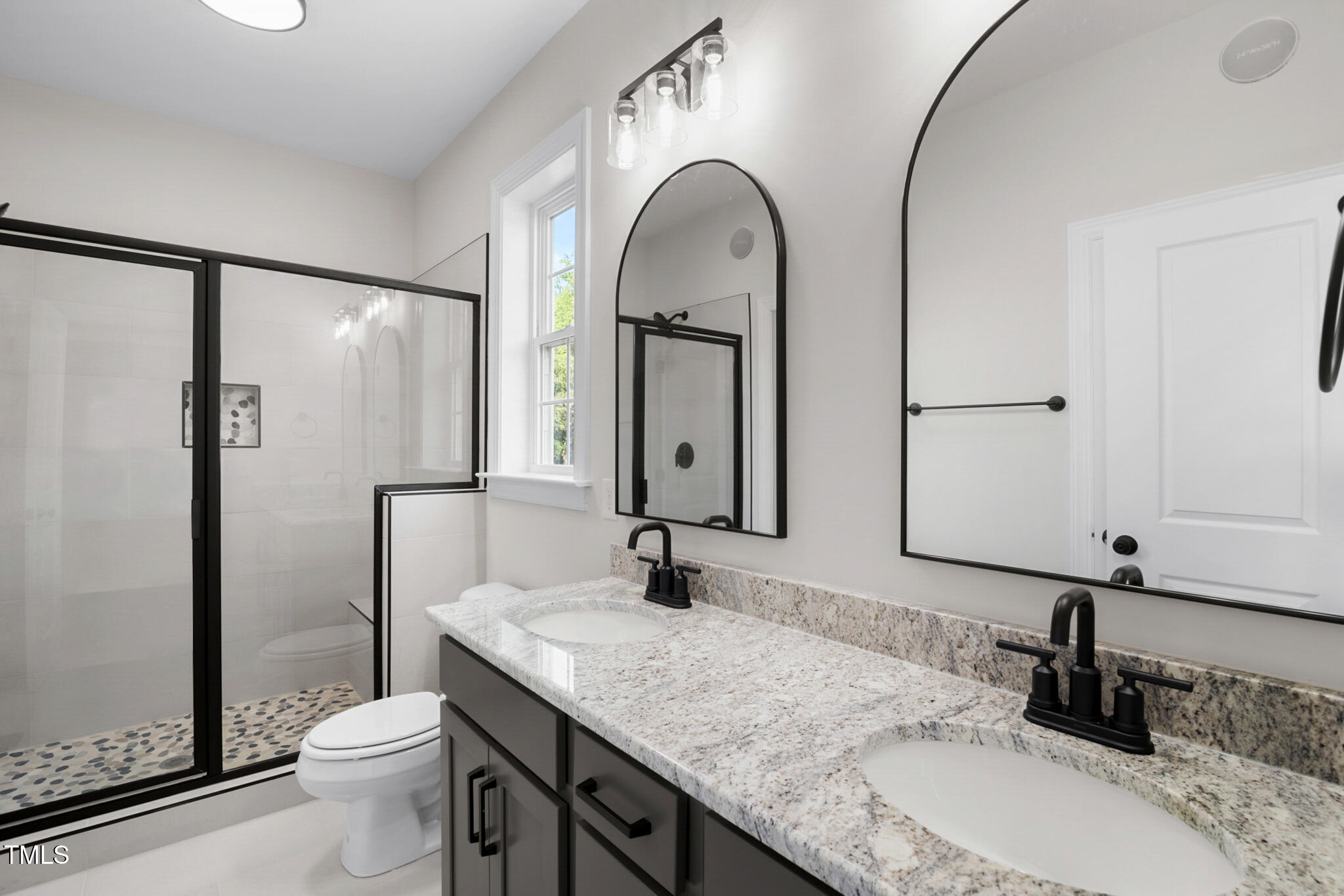 4948 Zebulon Road Zebulon, NC 27597 - Photo 16 of 35 a bathroom with a granite countertop sink a toilet and a mirror