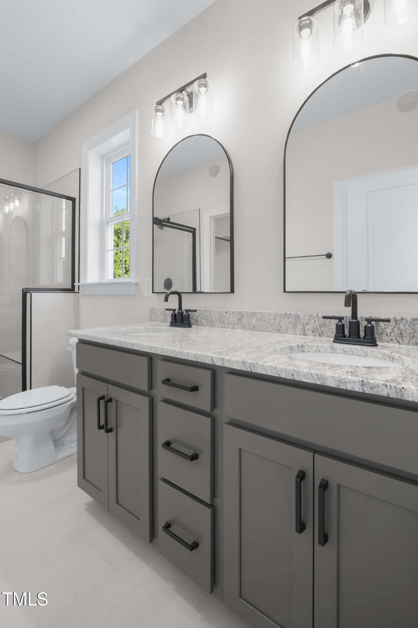 4948 Zebulon Road Zebulon, NC 27597 - Photo 18 of 35 a bathroom with double sink and a mirror
