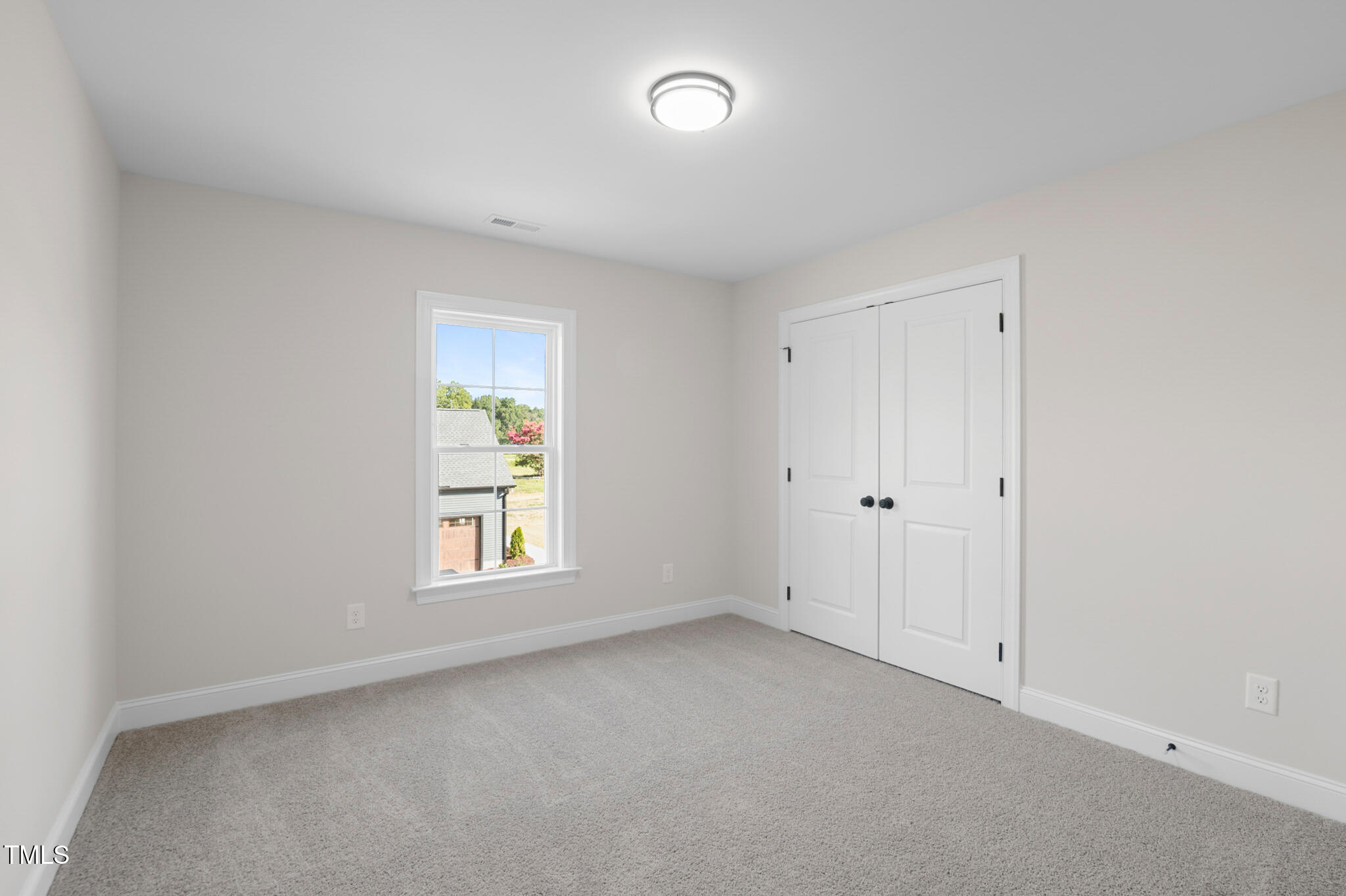 4948 Zebulon Road Zebulon, NC 27597 - Photo 21 of 35 a view of an empty room with a window