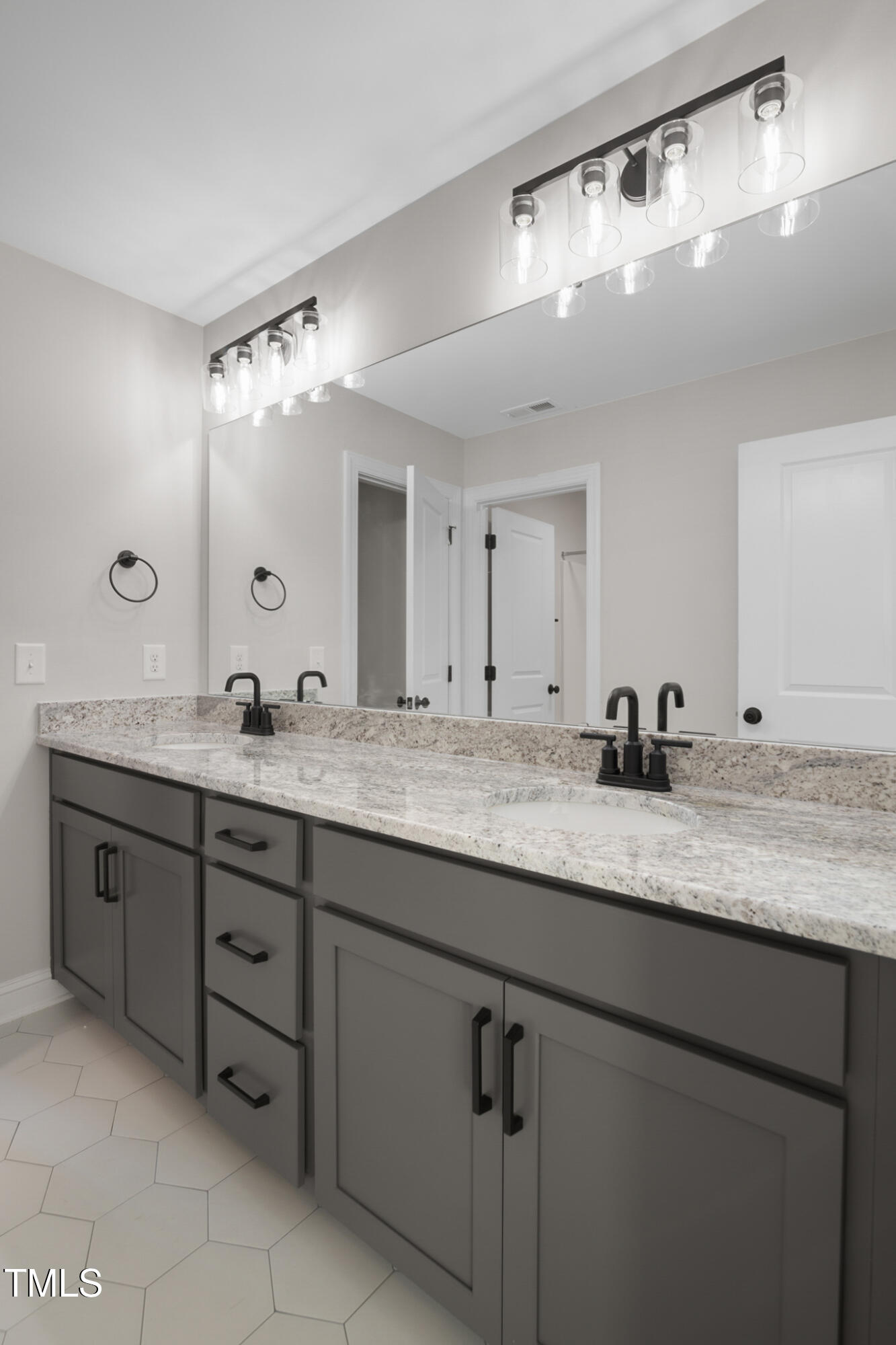 4948 Zebulon Road Zebulon, NC 27597 - Photo 24 of 35 a bathroom with double sink and a mirror