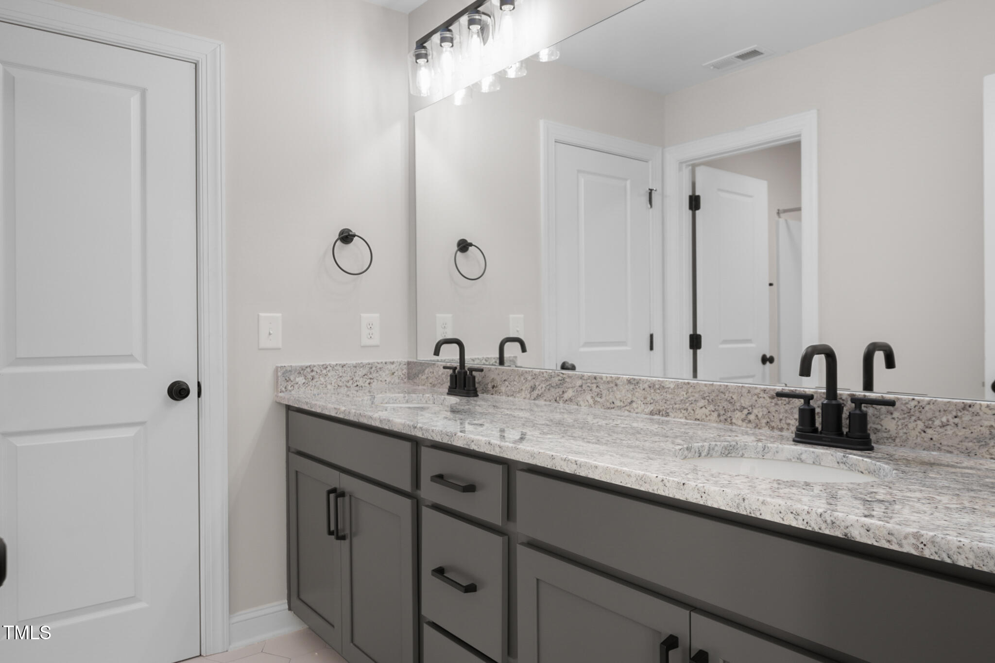 4948 Zebulon Road Zebulon, NC 27597 - Photo 26 of 35 a bathroom with a granite countertop sink and a mirror