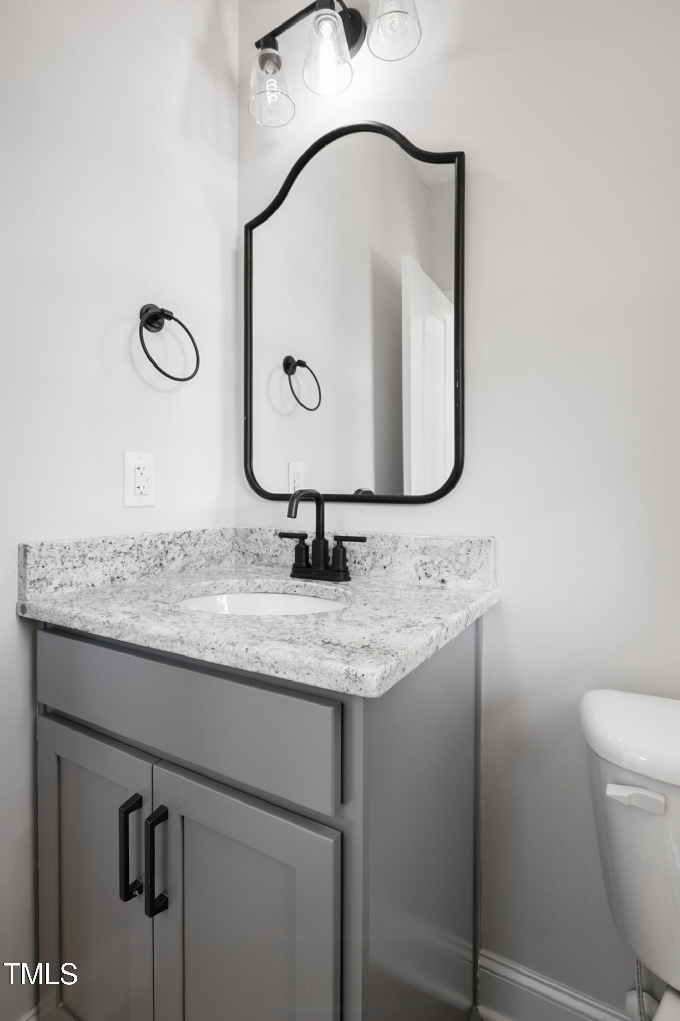 4948 Zebulon Road Zebulon, NC 27597 - Photo 5 of 35 a bathroom with a granite countertop sink a toilet and a mirror