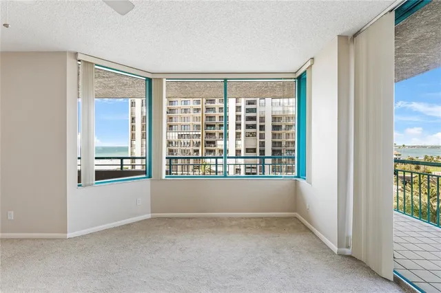 an empty room with a empty space and windows