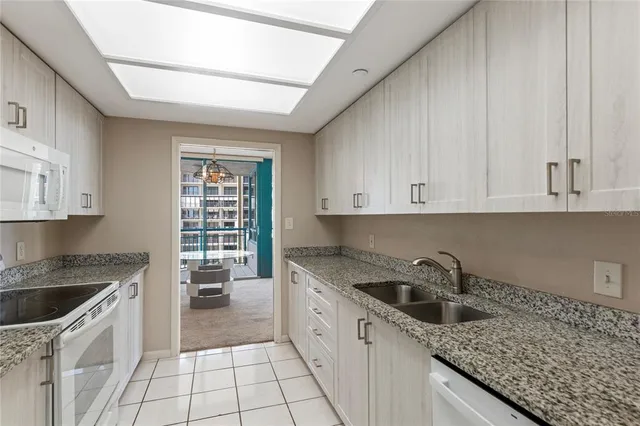 a kitchen with a sink stove and cabinets
