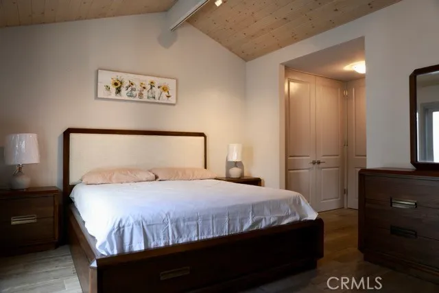 a bedroom with a bed and a night stand