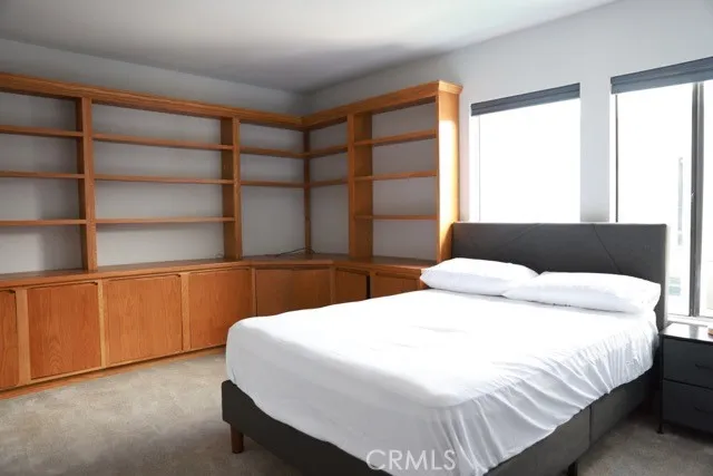 a bedroom with a bed and a wall painting