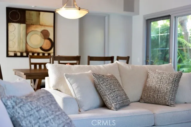 a living room with a bed furniture and a flat screen tv