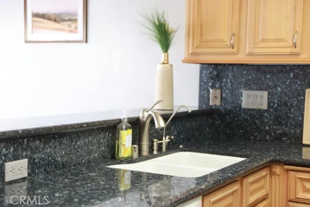 a kitchen with a sink a stove and a refrigerator