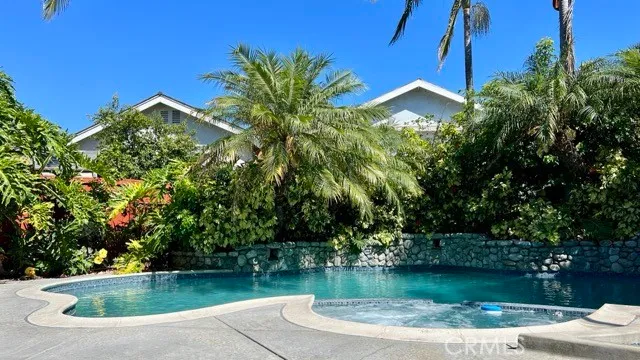 a view of a swimming pool with a patio and a yard