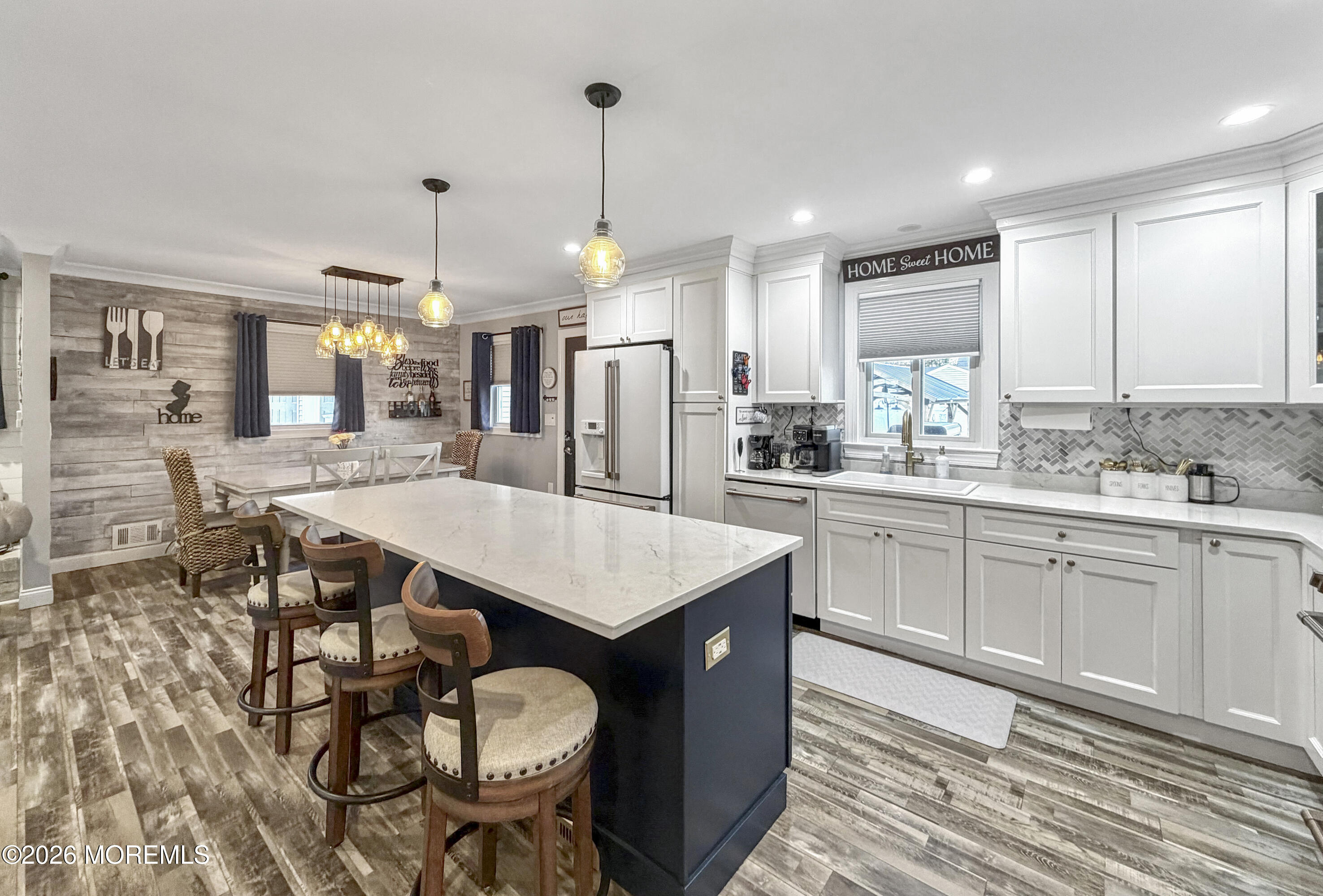 191 Summit Avenue Middletown, NJ 07718 - Photo 17 of 38 a kitchen with a dining table chairs sink and cabinets