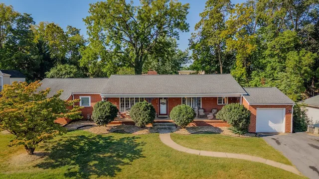 a view of a house with swimming pool and sitting area