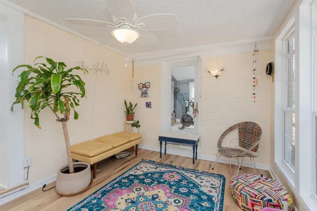 a living room with furniture and wooden floor