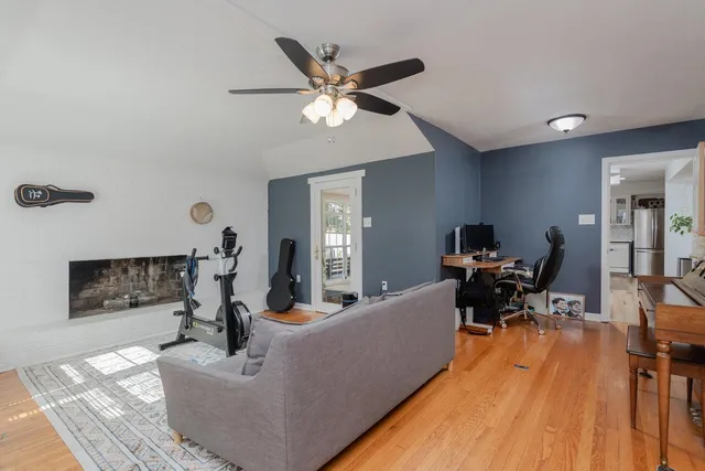 a living room with furniture a flat screen tv and a fireplace