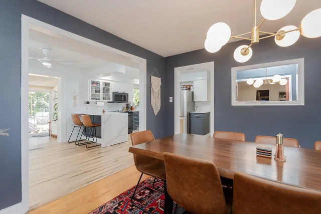 a view of a dining room with furniture and a floor to ceiling window