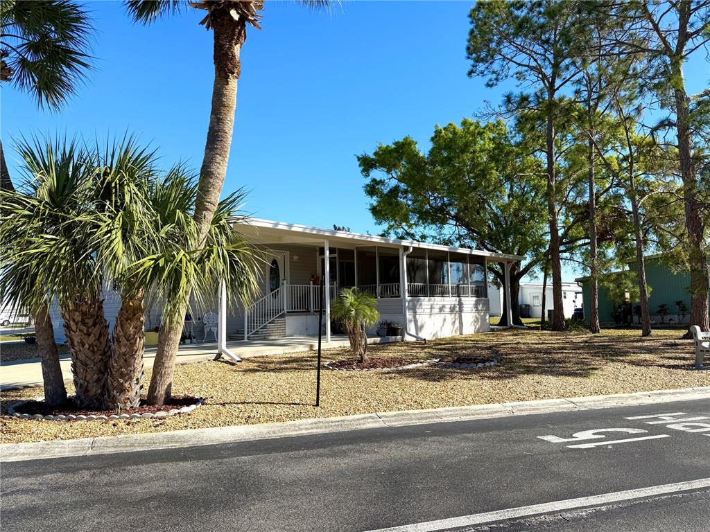 101 St Johns Way West Apollo Beach, FL 33572 - Photo 2 of 24 a front view of a house with a garden and tree