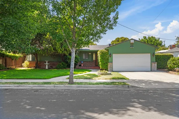 a house with a yard and a large parking space