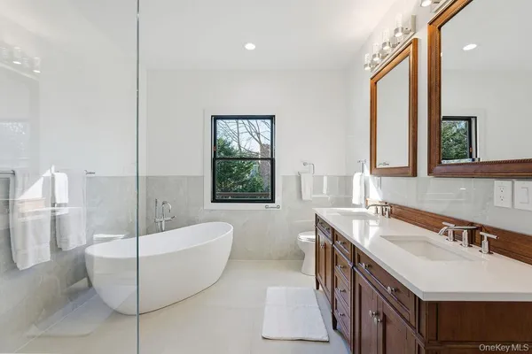 a bathroom with a bathtub a sink and a mirror