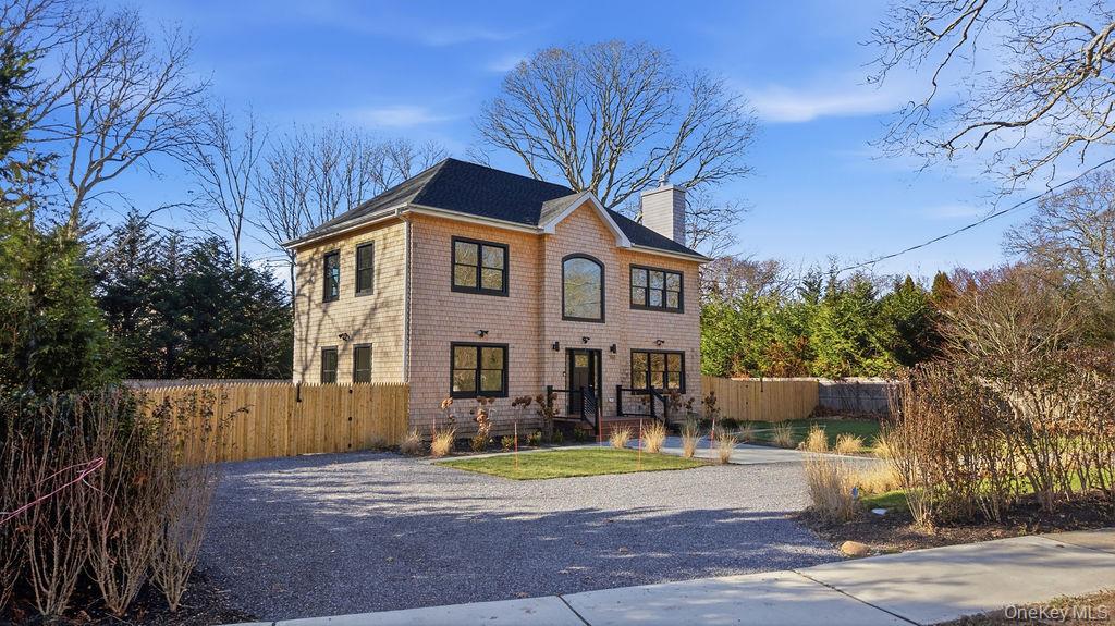 768 Bridgehampton Sag Harbor Westhampton Beach, NY 11978 - Photo 2 of 35 a front view of a house with a yard