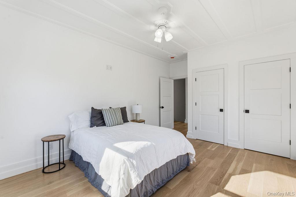 768 Bridgehampton Sag Harbor Westhampton Beach, NY 11978 - Photo 22 of 35 a spacious bedroom with a bed and a chandelier