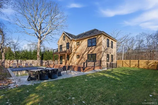 a view of a house with a big yard and large trees