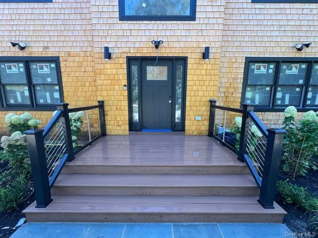 a front view of a house with stairs