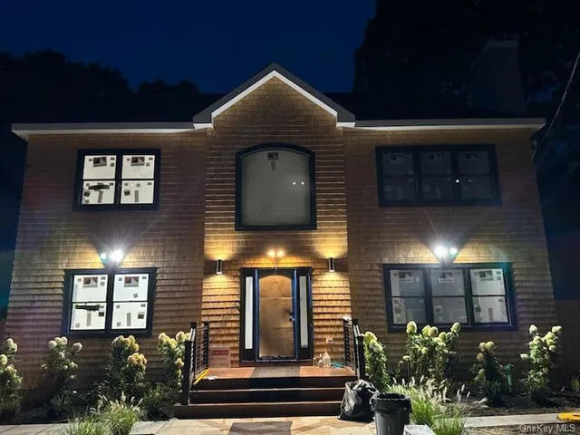 a front view of a house with plants