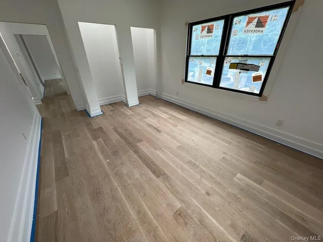 a view of a hallway with a wooden floor