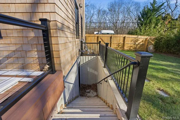 a view of balcony with wooden floor and fence and trees