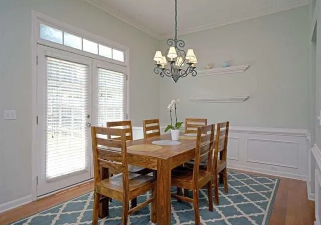 a view of a dining room with a table and chairs